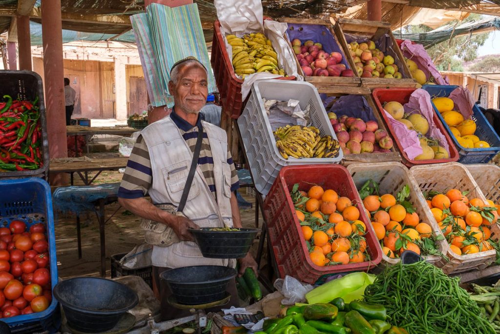 A Moroccon  farmer selling his produce at the market